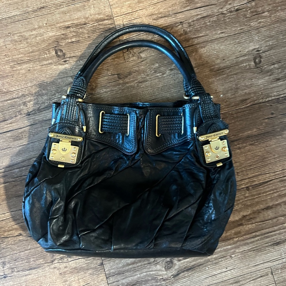 Juicy Couture shoulder hobo bag with locks at handles.